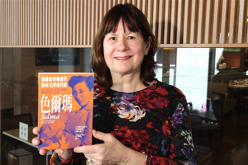 Carolijn Visser, the author of “Selma,” poses for photo with the Chinese version of the book published in Taiwan last December. CNA photo Feb. 19, 2024